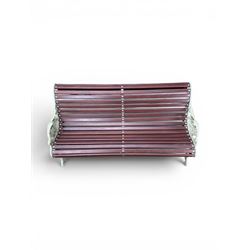 Large late Victorian cast iron garden bench, serpentine form with scroll back and seat, slatted with mahogany stained Sapele