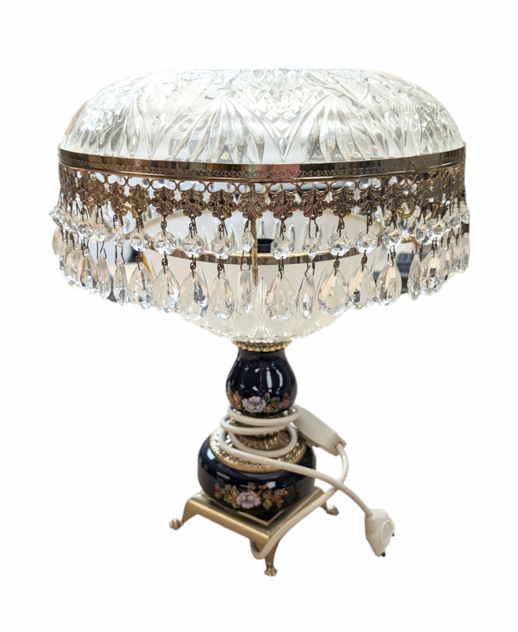 Ceramic table lamp, decorated with florals on a blue ground, with frosted glass shade with glass droplets, with two pin plug