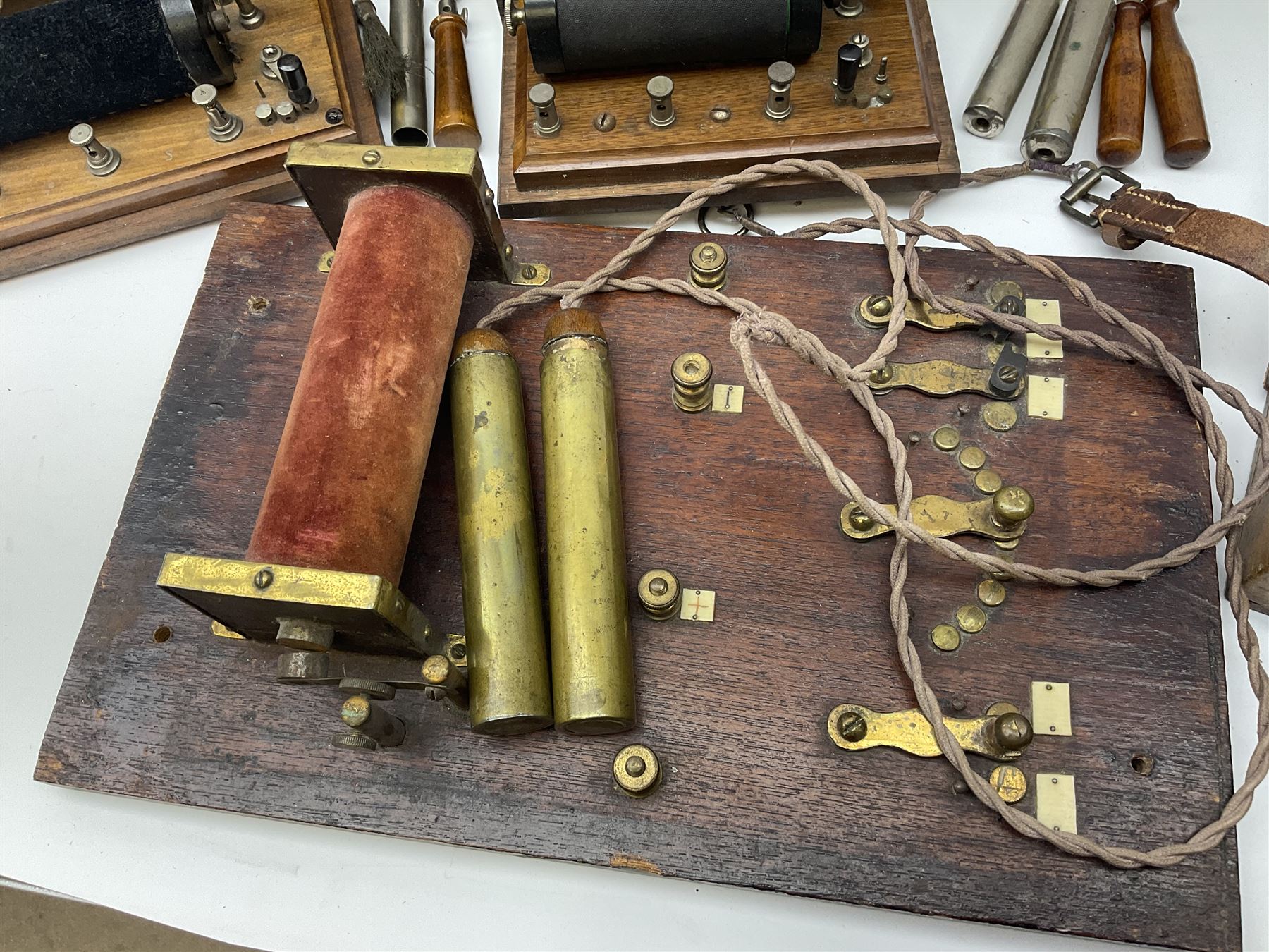 Heeling Error Instrument Patt.5 No.1613E (box numbered 1810E) with integrated spirit level D11cm; two walnut cased electric shock machines; and a similar board mounted electric shock machine (4)