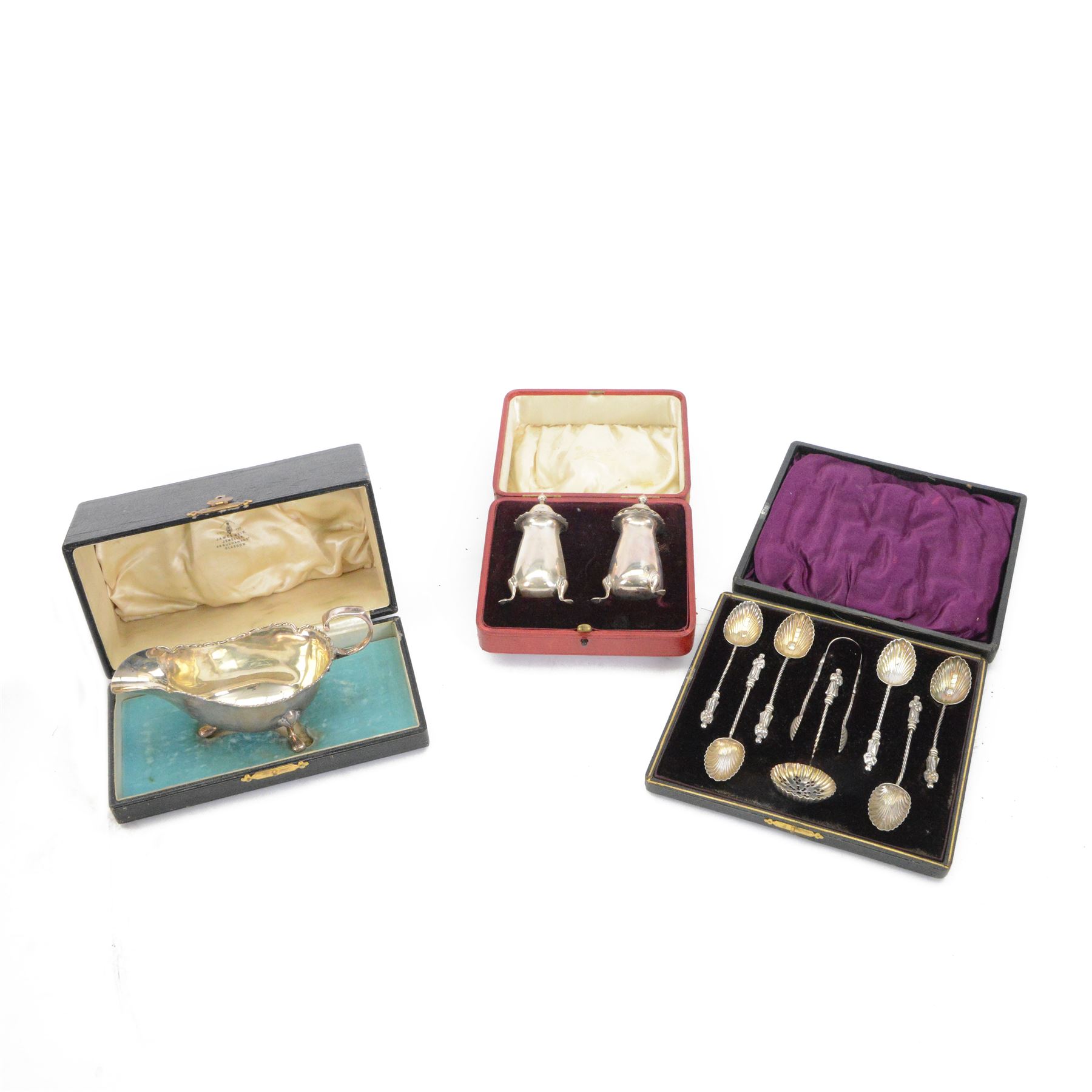 Edwardian silver sauce boat, of typical plain form with shaped rim, with flying C scroll handle and upon three pad feet, hallmarked Birmingham 1907, maker's mark worn and indistinct, together with a pair of Edwardian silver cruets, of urn form, upon three pad feet, hallmarked Horace Woodward & Co Ltd, Birmingham 1905 and a set of six silver apostle spoons, with matching sugar tongs and sugar sifting spoons, some hallmarked Miller Bros, London 1895 and Charles Boynton, all contained within fitted cases