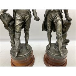 After S. Kinsburger, pair of early 20th century polished spelter figures of Lord Nelson and Arthur Wellesley, each depicted wearing full uniform and standing beside a rock; inscribed S. Kinsburger H39cm; on later turned mahogany bases H47cm overall (2)