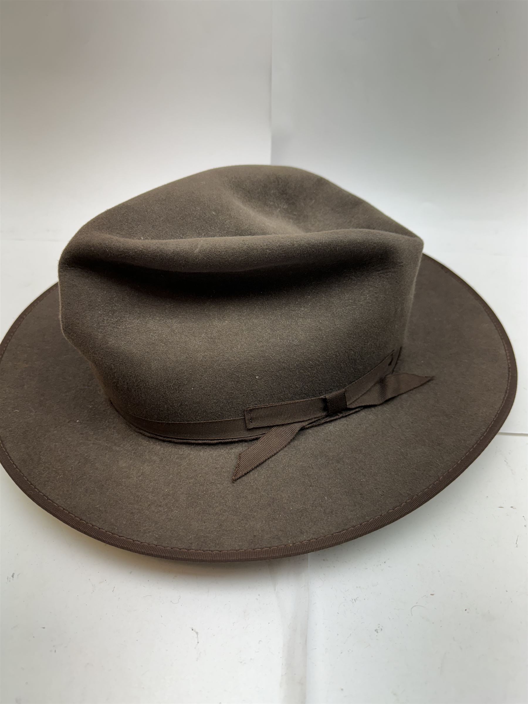 Akubra pure fur felt trilby hat, together with another trilby and two top hats, one by Woodrow and one by Dunn & Co