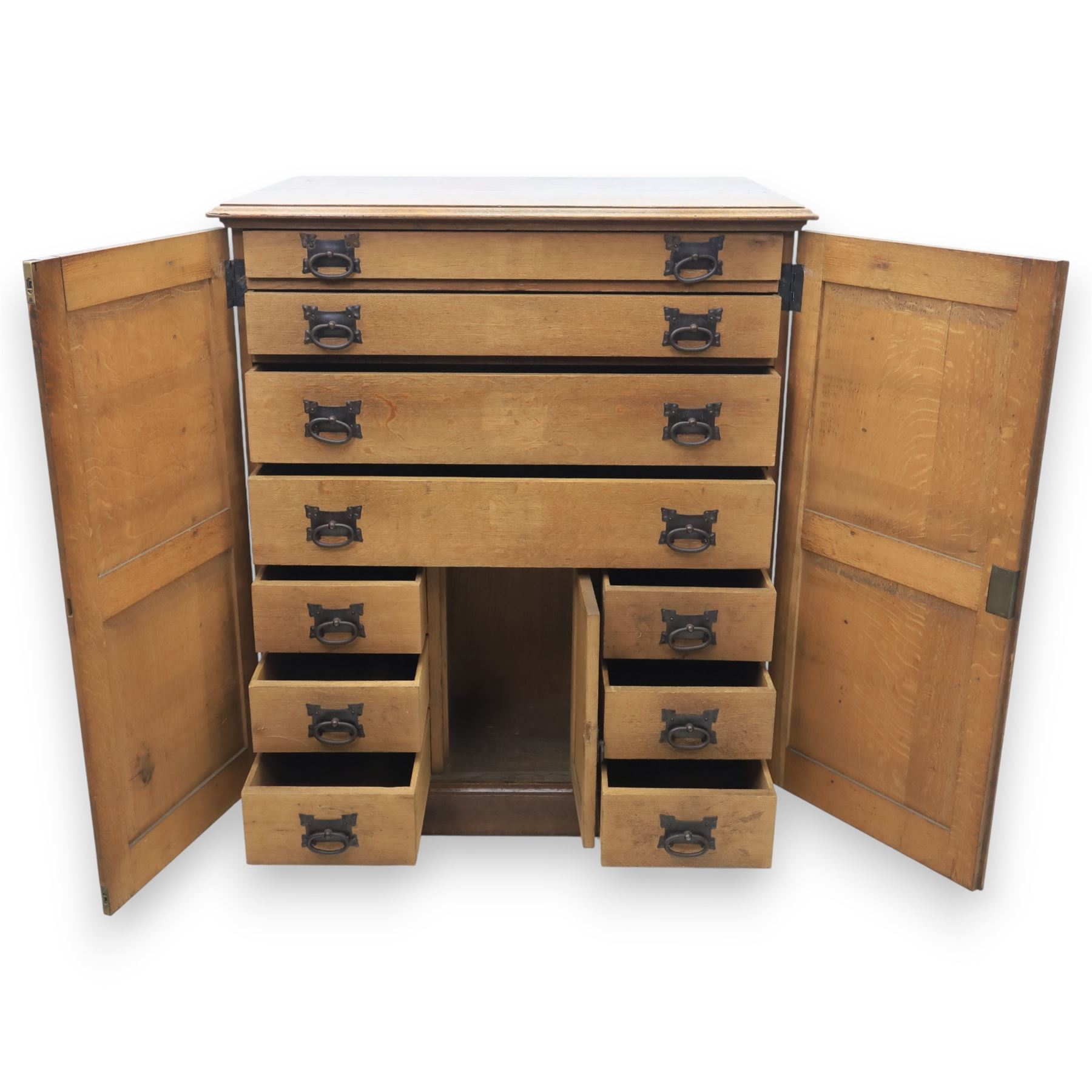 20th century oak Arts and Crafts fitted collector's cabinet, twin panelled doors with metal door pulls, enclosing a fitted interior, on a moulded plinth base