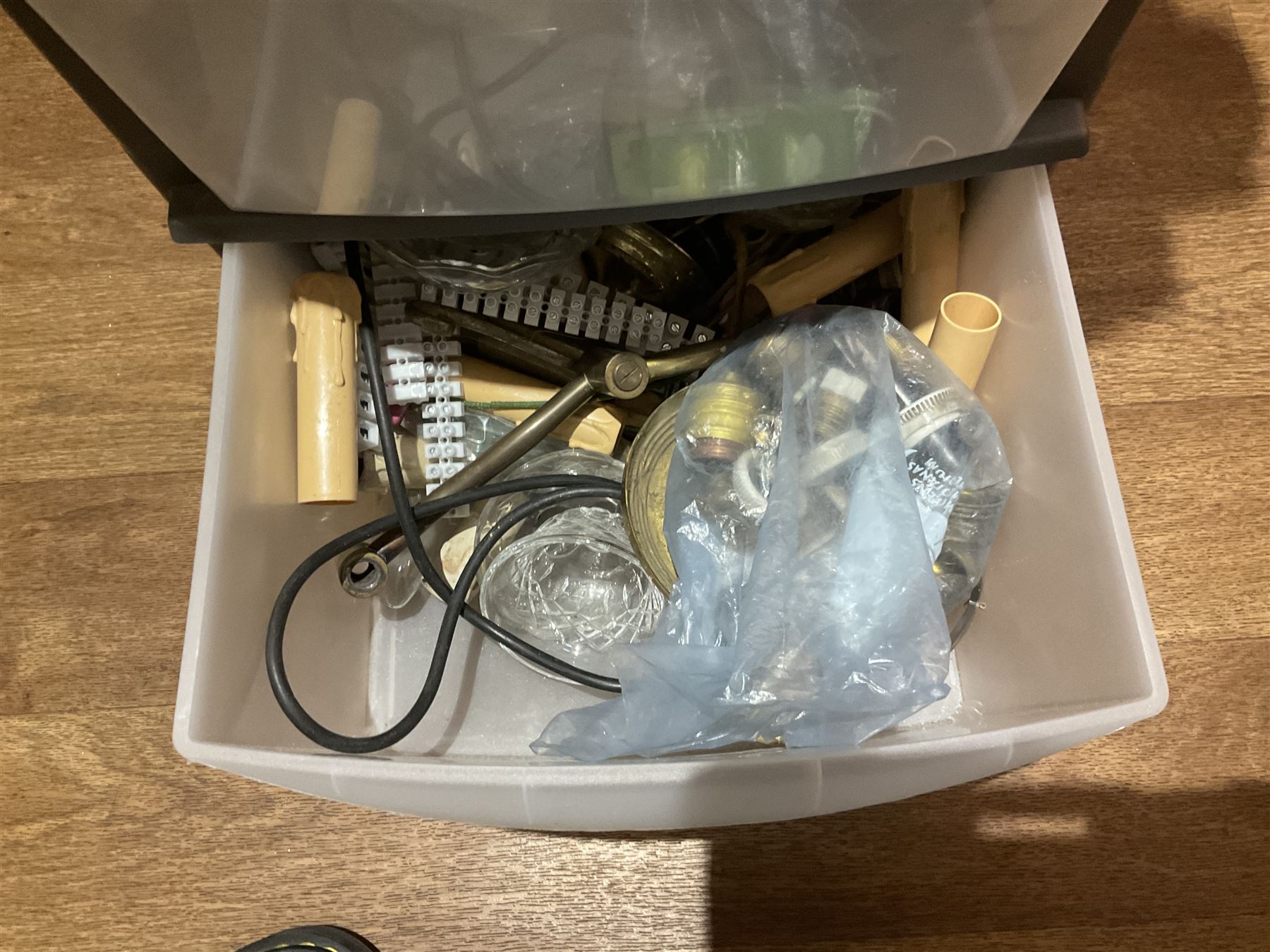 Large quantity of light fitting spare parts and accessories in plastic floor standing six-drawer chest