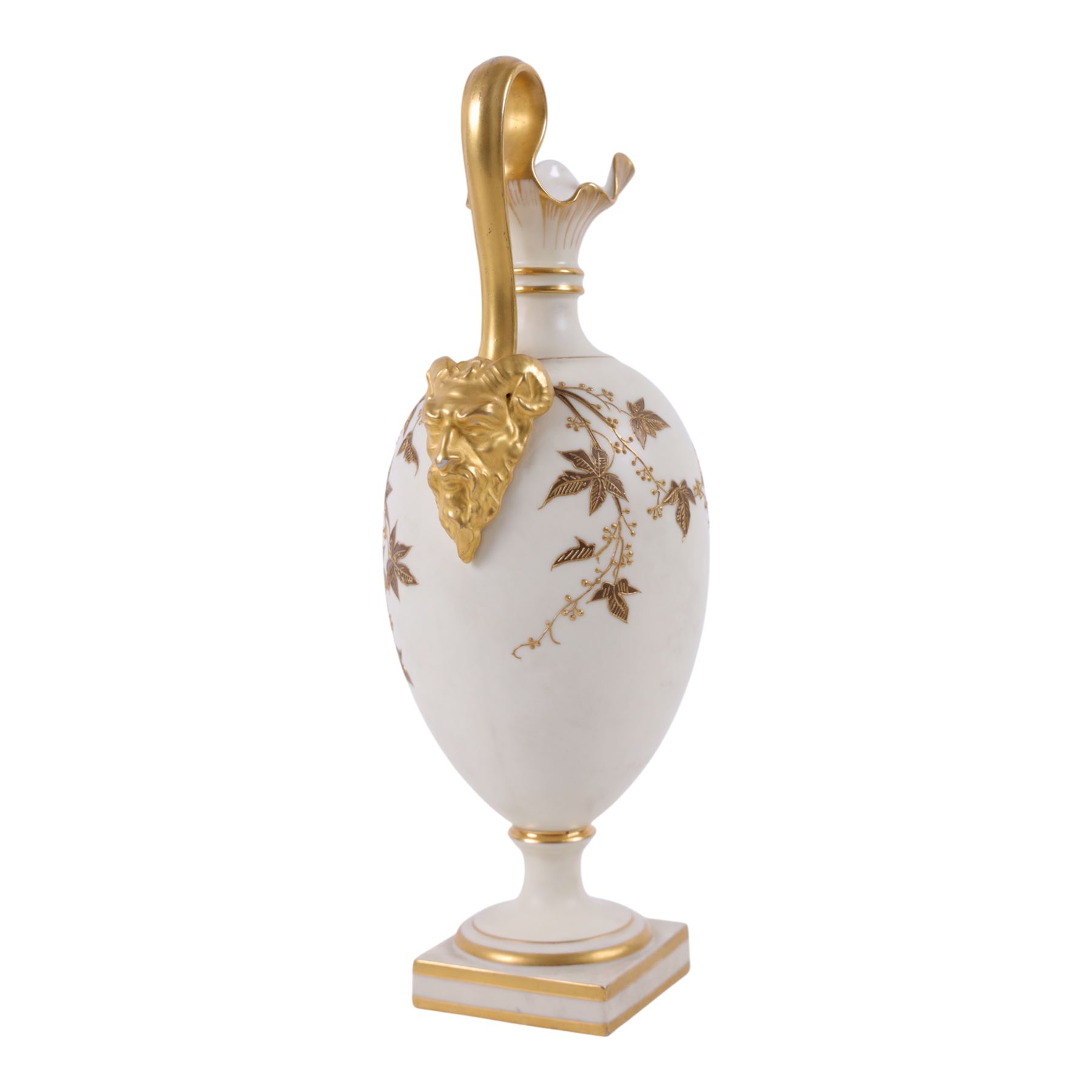 Royal Worcester Blush Ivory ewer, on a gilt square foot with a gilt crimped rim and high arched handle and mask, painted with gilt foliage shape 1144, together with fluted ewer decorated with gilt flowers shape 1361, both with puce mark beneath, largest H29cm