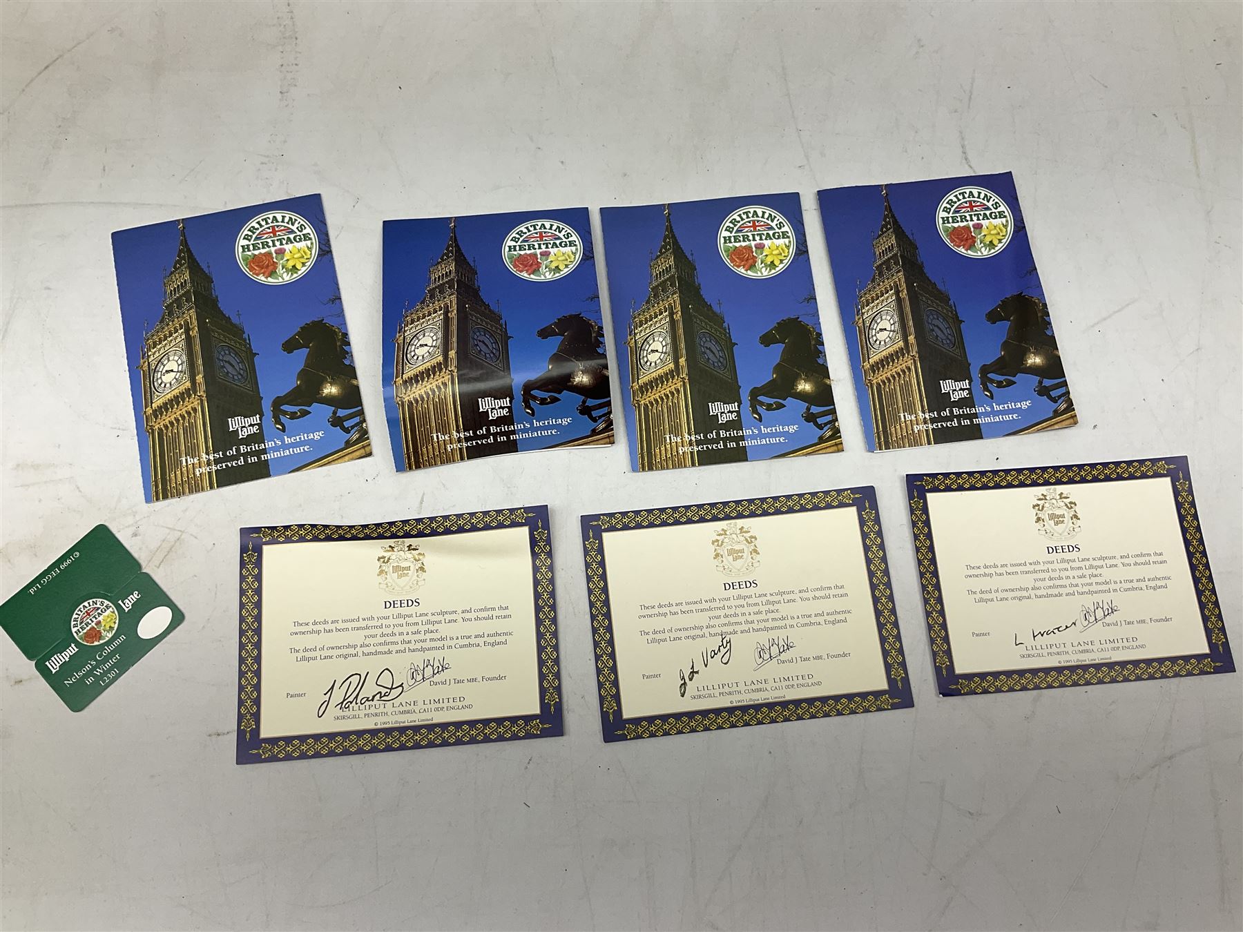 Five Lilliput Lane models from the 'Britain's Heritage' collection, comprising The Royal Albert Hall, Windsor Castle Round Tower, Eros and Nelson's Column and another snowed, all boxed