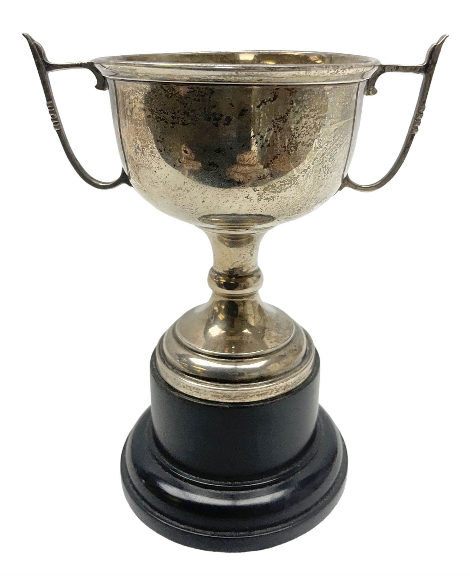 1930's silver twin handled trophy cup, upon black circular plinth, hallmarked Birmingham 1936, approximate silver weight 47 grams