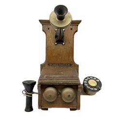 Early 20th century wall mounted telephone, with ring dial and hand held earphone housed on brass fixtures under the fixed mouthpiece, the shaped wood body with original painted 'The National Telepone Co Ltd.' detail, H49cm