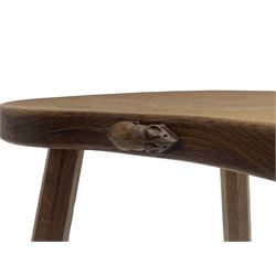 'Mouseman' oak three-legged stool, kidney shaped dished seat carved with mouse signature to edge, by Robert Thomas of Kilburn