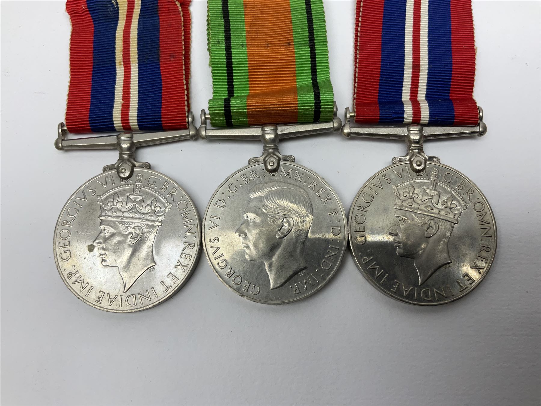 Twelve WW2 medals comprising four 1939-1945 war medals, four Defence medals, three 1939-1945 Stars and Africa Star; all with ribbons; some as groups in two issue boxes with slips