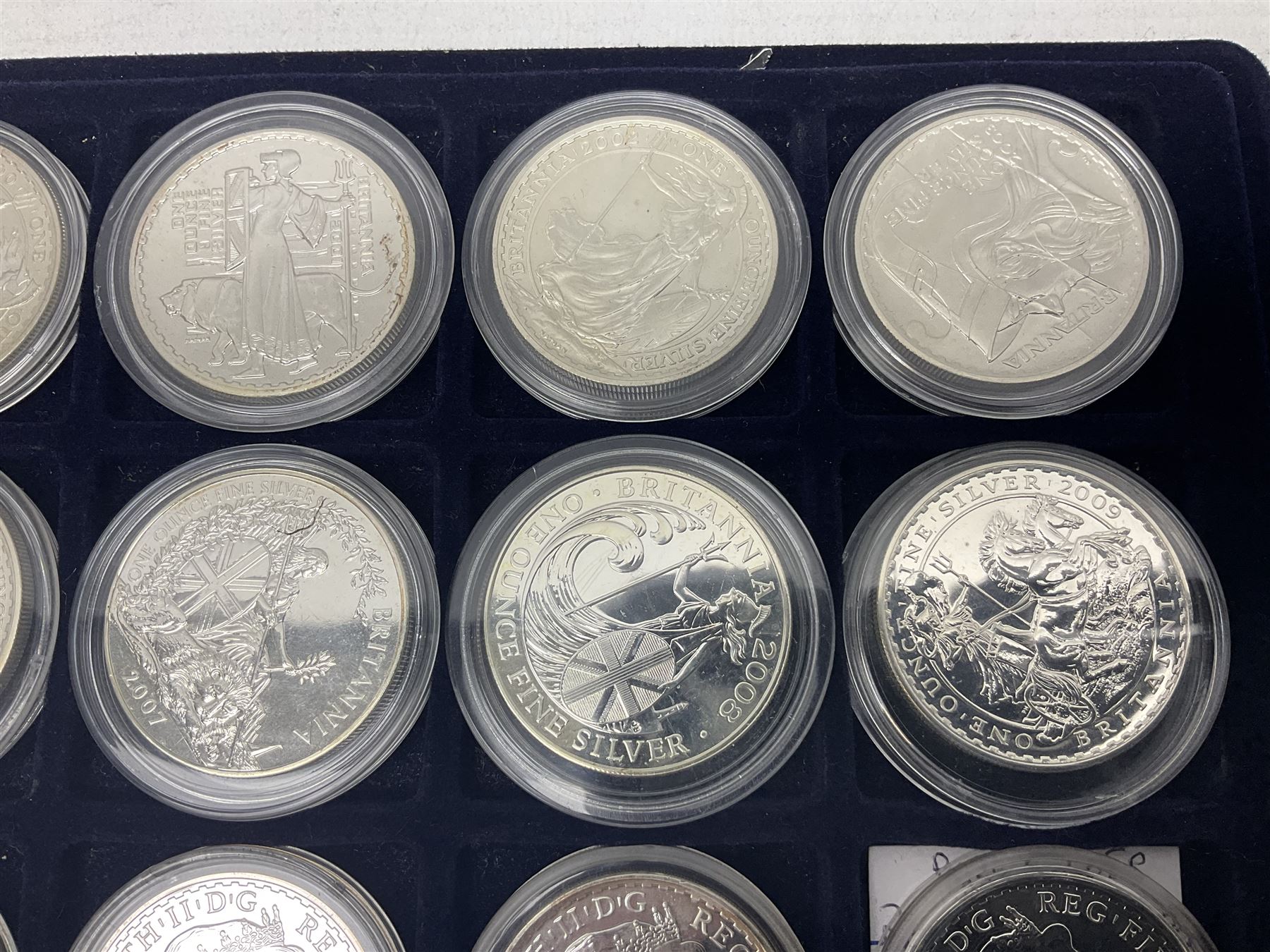 Twenty-four Queen Elizabeth II Britannia one ounce fine silver two pound coins, dated 1998, 1999, 2000, 2001, 2002, 2003, 2004, 2005, 2006, 2007, 2008, 2009, 2010, 2011, 2012, 2013, two 2014, 2015, 2016, 2017, 2018, 2019 and 2020 (24), housed on a coin tray