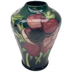 Moorcroft vase, of baluster form, decorated in the Anemone Tribute pattern designed by Emma Bossons, with impressed and painted marks beneath, H11cm, with maker's box, together with a Moorcroft bell, decorated in the Hibiscus pattern and dated 1983, with printed and painted marks to the interior, H11cm. (2). 
