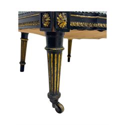 19th century French ebonised low chair, upholstered in floral striped fabric within a moulded frame with gilt line and foliate decoration, the seat of serpentine form, raised on turned fluted legs with toupie feet