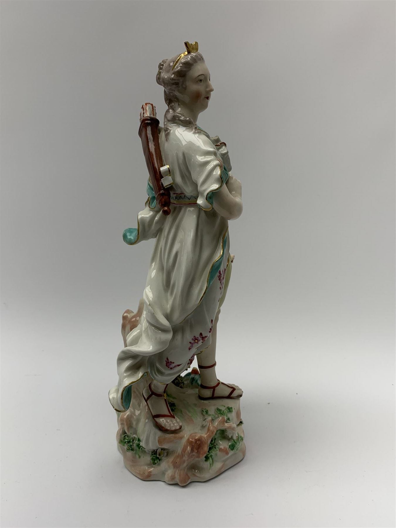 Mid 18th century Derby porcelain figure modelled as Dianna the Huntress, with quiver of arrows upon her back and dog by her side, upon a naturalistically modelled base, with patch marks beneath and collectors labels, H26cm