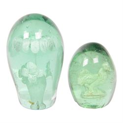 Two 19th century green glass dump paperweights, each of globular form, the smaller example with internal sulphide cockerel, H9cm, the larger with internal sulphide floral bloom, H13cm