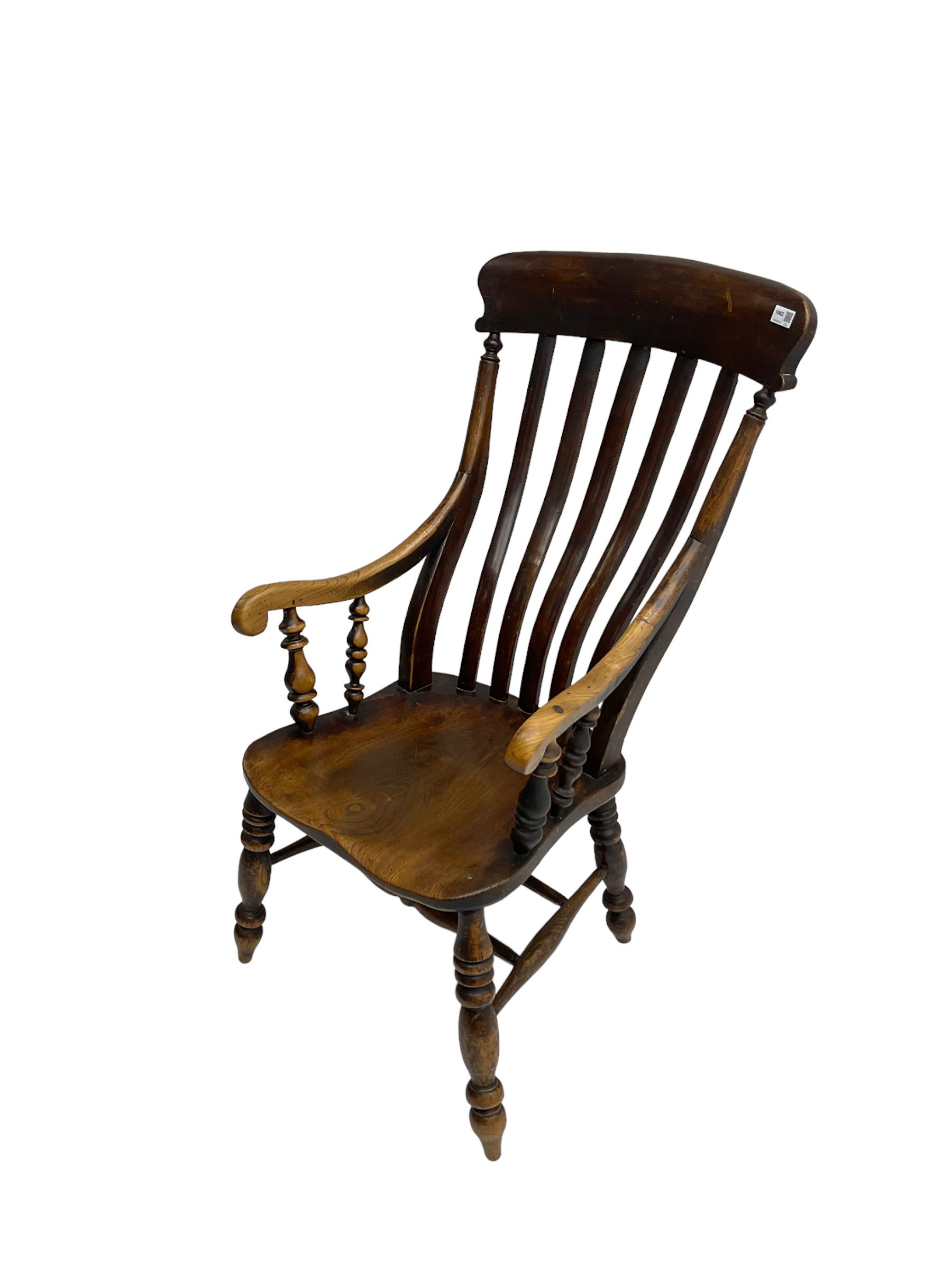 Late 19th century elm farmhouse armchair, high lath back raised on turned supports united by stretcher