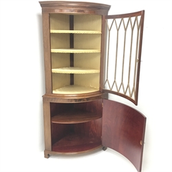 20th century figured mahogany bow front corner cabinet, projecting cornice, dentil frieze, single door enclosing three lined shelves above cupboard door, shaped bracket supports, W90cm, H199cm, D65cm
