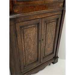 George III oak floor standing corner cabinet, scrolled swan neck pediment with central finial over astragal glazed door, painted interior fitted with three shaped shelves, the lower section fitted with single shaped shelf enclosed by two fielded panel doors inlaid lozenges, on bracket feet, H195cm, W77cm