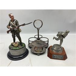 Walker & Hall silver plated RAF mess cruet frame H16.5cm; after Chas C. Stadden, a presentation pewter figure of a WW2 RAF fighter pilot in a Battle of Britain 'Scramble' pose bearing RAF Marham plaque; and a limited edition figure after David Thatcher of a wounded soldier loading his gun No.2/25 (3)