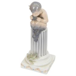 Two Royal Copenhagen figurines of fawns, comprising a fawn with an owl, no 2107 and fawn on plinth no 433, together with Bing & Grondahl, figure of a parrot on branch