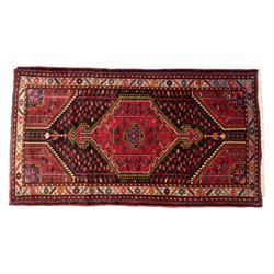 North west Persian Koliahee hand-knotted rug, central magenta field with elongated hexagon...