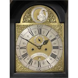 James Bowra of Sevenoaks Kent - 18th century 8-day ebonised longcase clock with gilt decoration c1740, with a flat top, dentil moulding beneath and shaped back splats, break arch hood door flanked by plain pilasters with wooden capitals, long trunk with a curved topped door, on a square plinth with canted corners and raised on a moulded base, brass dial with cast spandrels and a silvered 'Punch' automata to the arch, matted dial centre with seconds ring and date aperture, silvered chapter ring with Roman numerals, five minute Arabics, minute and quarter hour tracks, with matching steel hands and silvered makers name plate, rack striking movement with a recoil anchor escapement, striking the hours on a bell. With weights and pendulum.