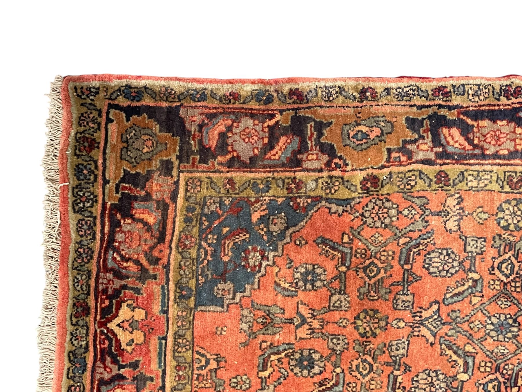 Persian Zanjan pale red ground rug, lozenge medallion and field decorated with floral Herati motifs, the border decorated with stylised plant motifs and trailing branches, floral pattern guard stripes
