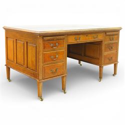 20th century oak kneehole desk, rectangular black leather inset top, above a single frieze drawer, flanked by two pedestals with slides and drawers, panelled sides and back 