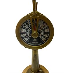 Early 20th century, illuminating brass ship's telegraph by Chadburns of Liverpool and London, on a circular wooden plinth, H55cm