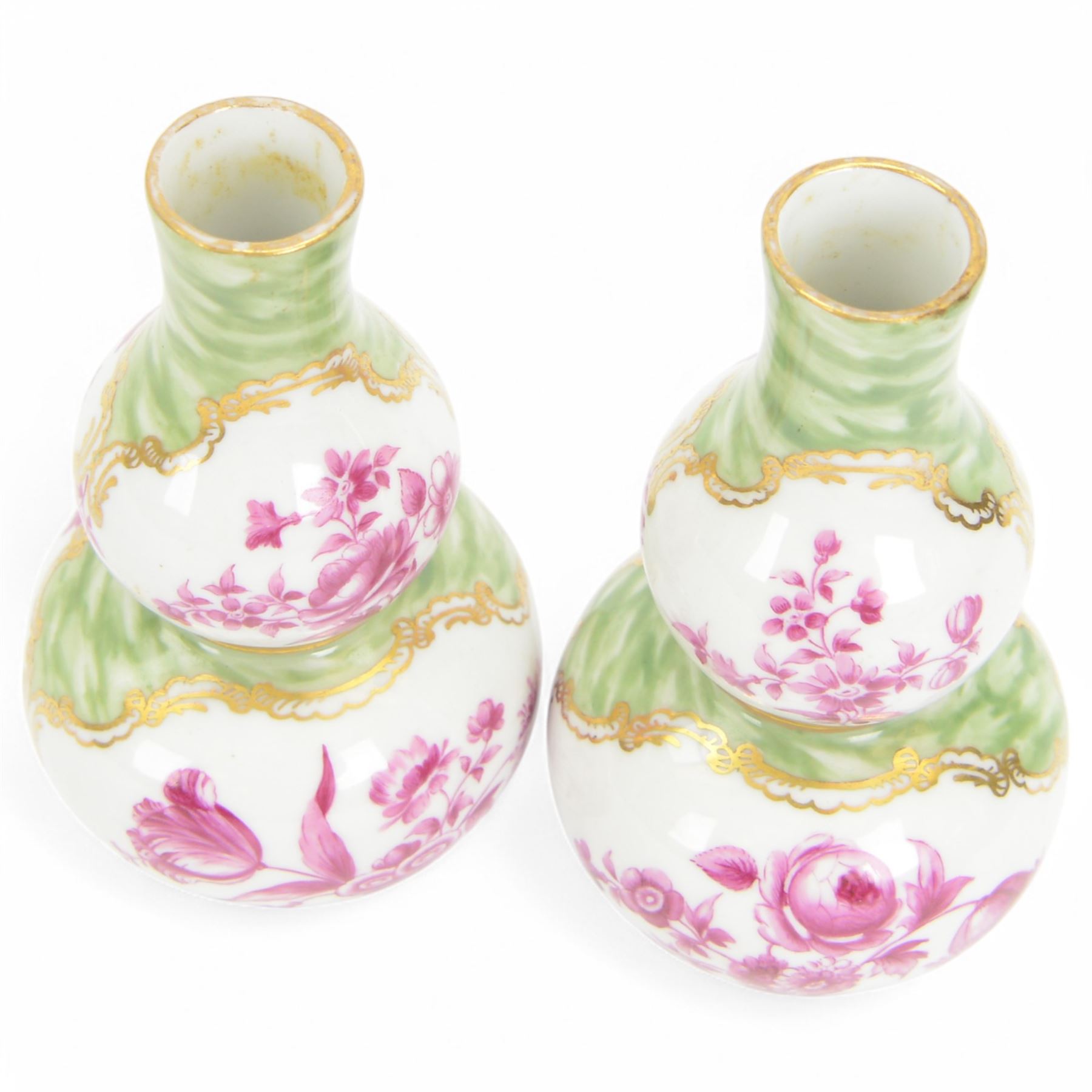Pair of small late 19th century German double gourd vases, probably Dresden, each hand painted in puce with reserves of a courting couple within a garden setting, and floral sprays upon a white ground, within a green painterly surround, each with very faint traces of blue marks to the unglazed base, H12.5cm