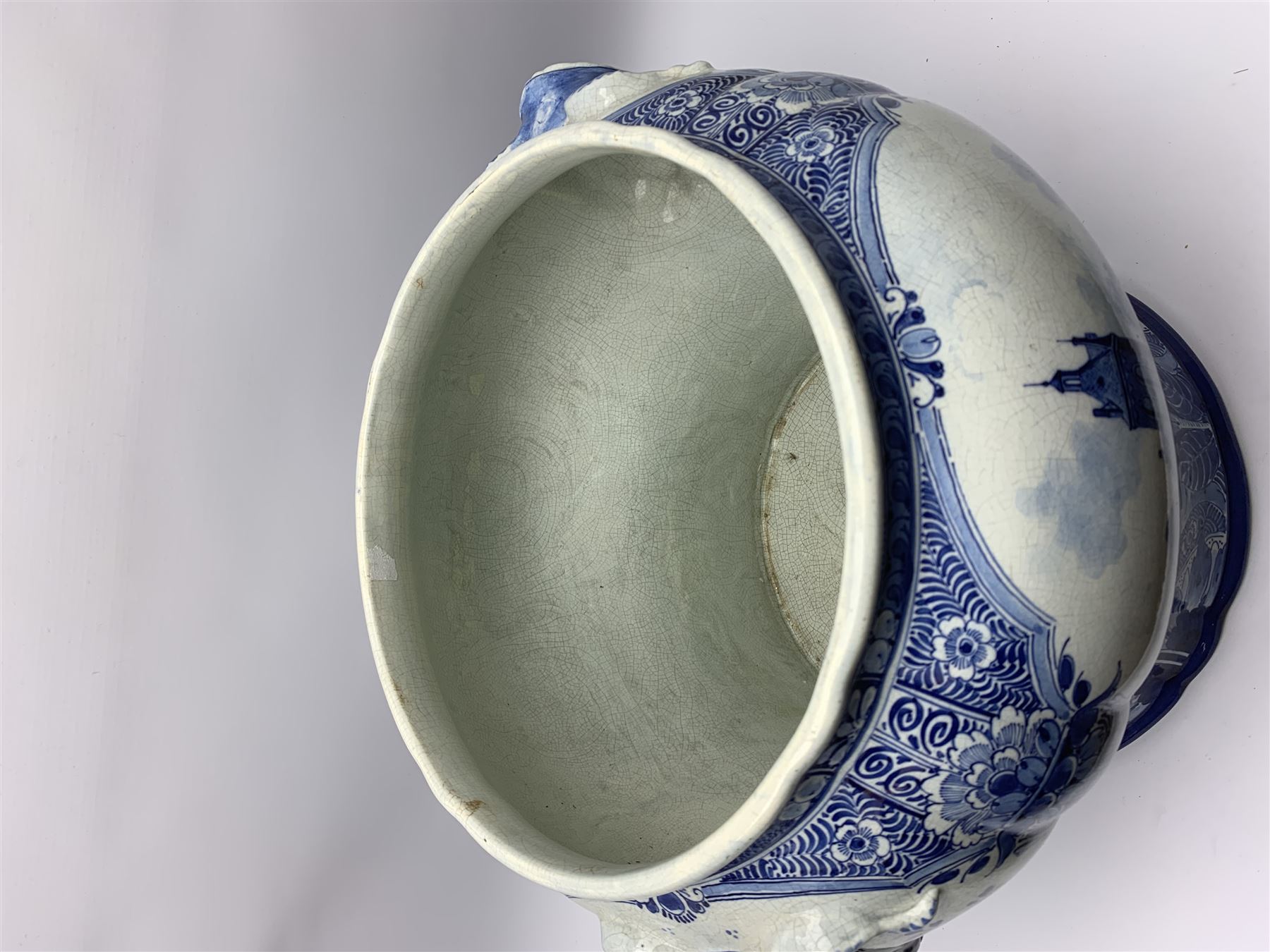 Large 20th century Delft blue and white jardinière, of baluster form with twin zoomorphic mask lug handles, decorated with hand painted panels of waterside scenes, within foliate surround, impressed and painted marks beneath for De Porceleyne Fles workshop, Delft, H35cm, rim D32