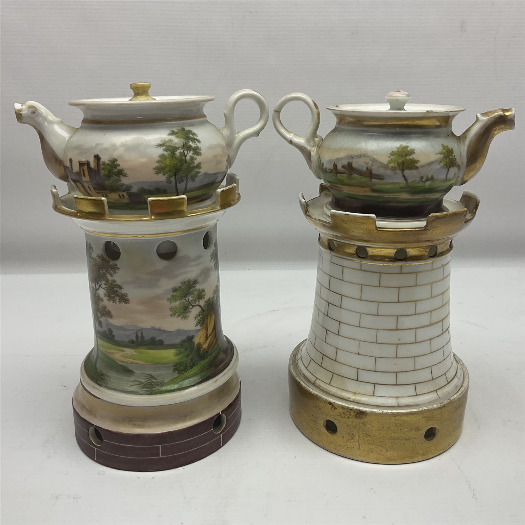 Two 19th century continental teapots and warmers, each teapot upon a cylindrical warming base, hand printed with landscapes and seascapes, largest H22cm
