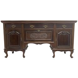 Late Victorian walnut sideboard, moulded rectangular top over three drawers  with blind fretwork facias, fitted with central fall front cupboard with extending foliage carved decoration and two flanking panelled cupboards, on acanthus carved cabriole feet