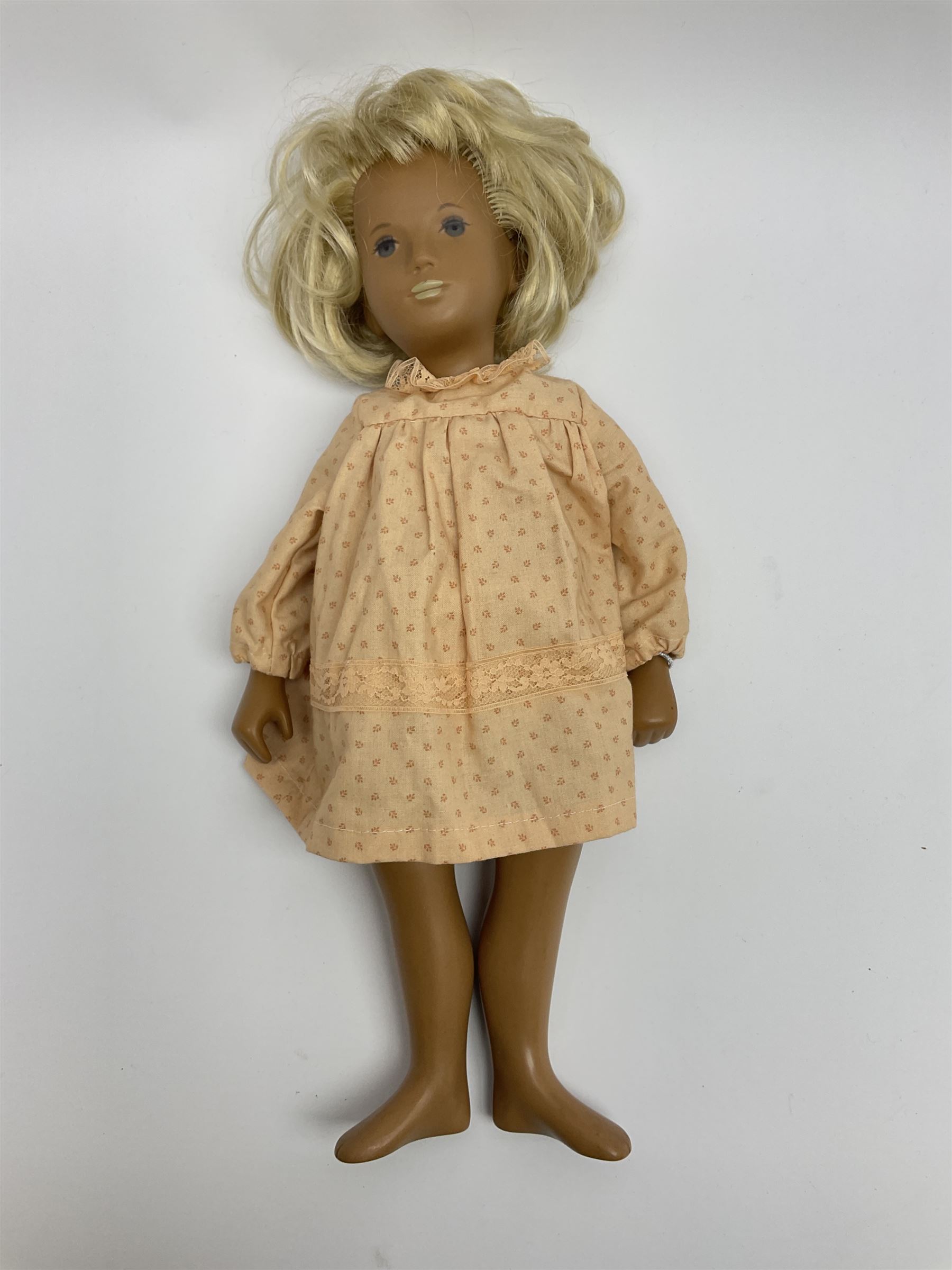 Sasha Morgenthaler vinyl doll, the girl's head with painted blue eyes and lips and short blonde hair, the jointed body donning a peach floral dress with matching underclothes, unmarked, H41cm