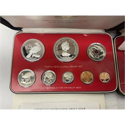 Four Papua New Guinea proof eight coin sets, from ten kina to one toea, comprising First Coinage of Papua New Guinea 1975 proof set, 1976, 1977, and 1979 proof sets, the 1977 and 1979 sets containing 925 silver ten kina and 500 silver five kina coins, all minted at the Franklin Mint, cased with certificates (4)