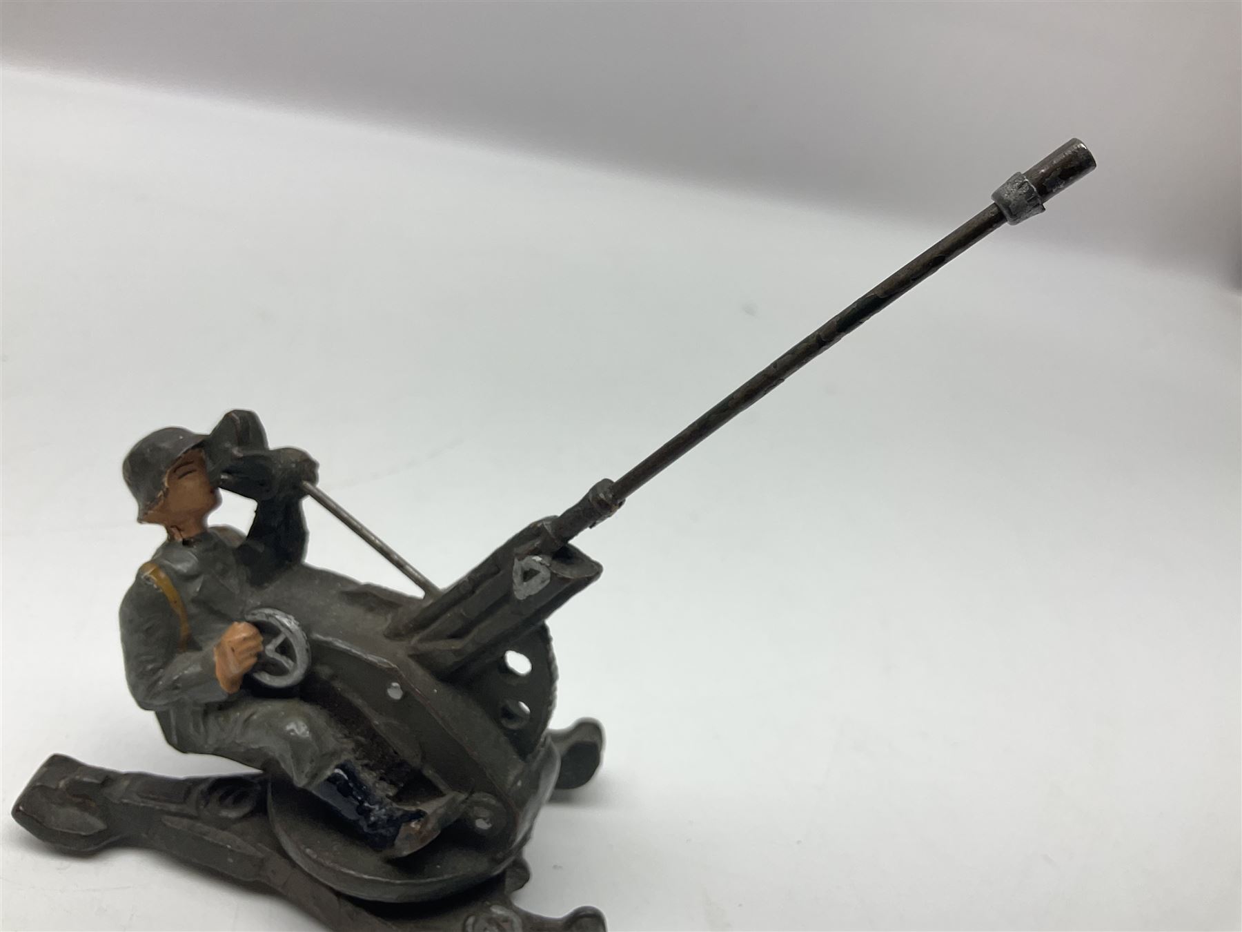 German Lineol Flak Artillery Gun on revolving base H11cm; four other Lineol WW2 German soldiers; and three Elastolin German soldiers including reclining radio operator (8)