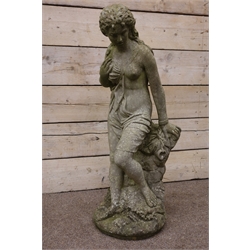  Composite stone garden sculpture of a semi-clad young Lady, on naturalistic circular base, H104cm   