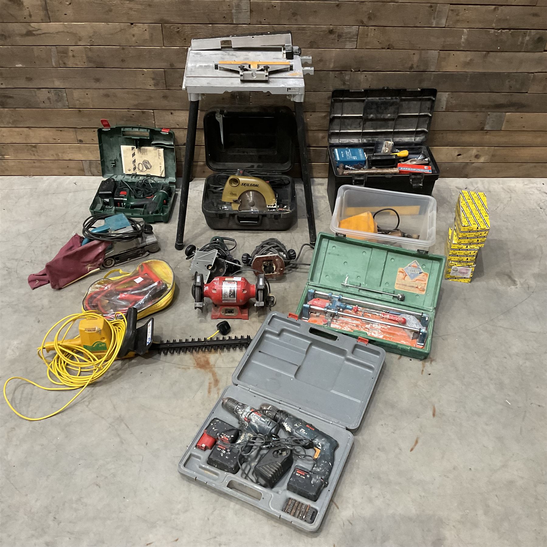 A quantity of power and hand tools including Skilsaw Classic circular saw, Makita 9401 belt sander, Bosch POF 52 router etc