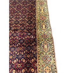 Persian Mahal rug, the blue ground field decorated with repeating Herati motifs, guarded pale ground border decorated with stylised panels