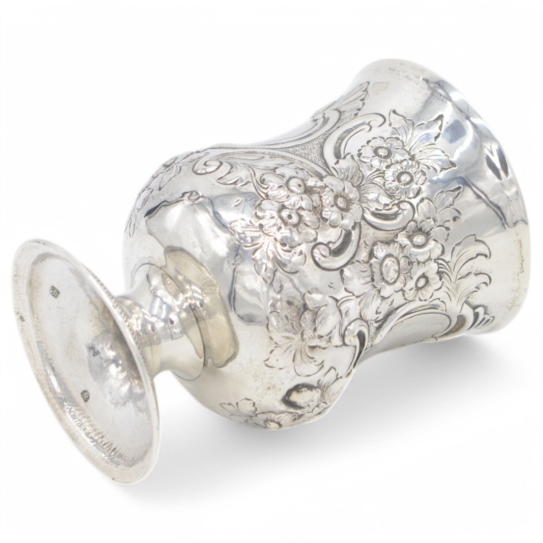 George III silver cup of circular form, embossed with scrolling and floral decoration, upon circular foot, hallmarked John Denzilow, London 1784, H13cm