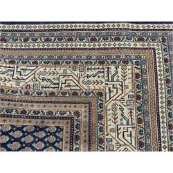 Large North-West Persian Arrak indigo ground carpet, the field decorated all-over with small Boteh motifs, multiple band border decorated with repeating geometric designs 