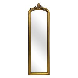 Narrow Victorian design gilt framed wall mirror, anthemion and scrolled acanthus leaf pediment over moulded frame, plain mirror plate 