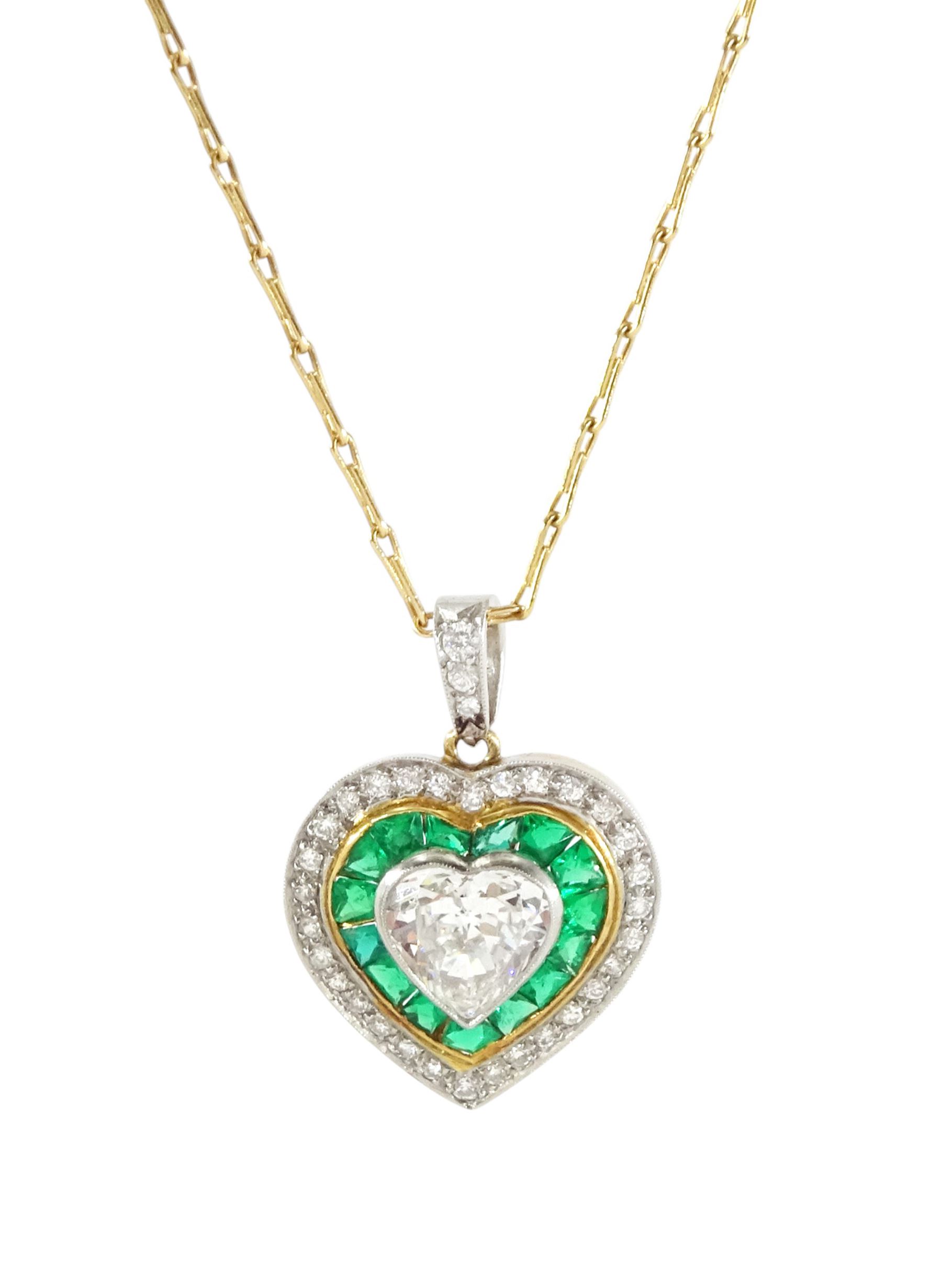 15ct gold and platinum diamond and emerald heart pendant, the principal milgrain set,  heart cut diamond of approx 1.00 carat, with calibre cut emerald and round cut diamond surround, on an 18ct gold fancy link chain necklace, hallmarked