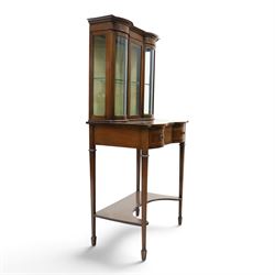 Edwardian inlaid mahogany serpentine-front side cabinet, raised back with central glazed door flanked by bow-front glass panels, the base fitted with banded and shaped frieze drawer, on square tapering supports united by concave under-tier