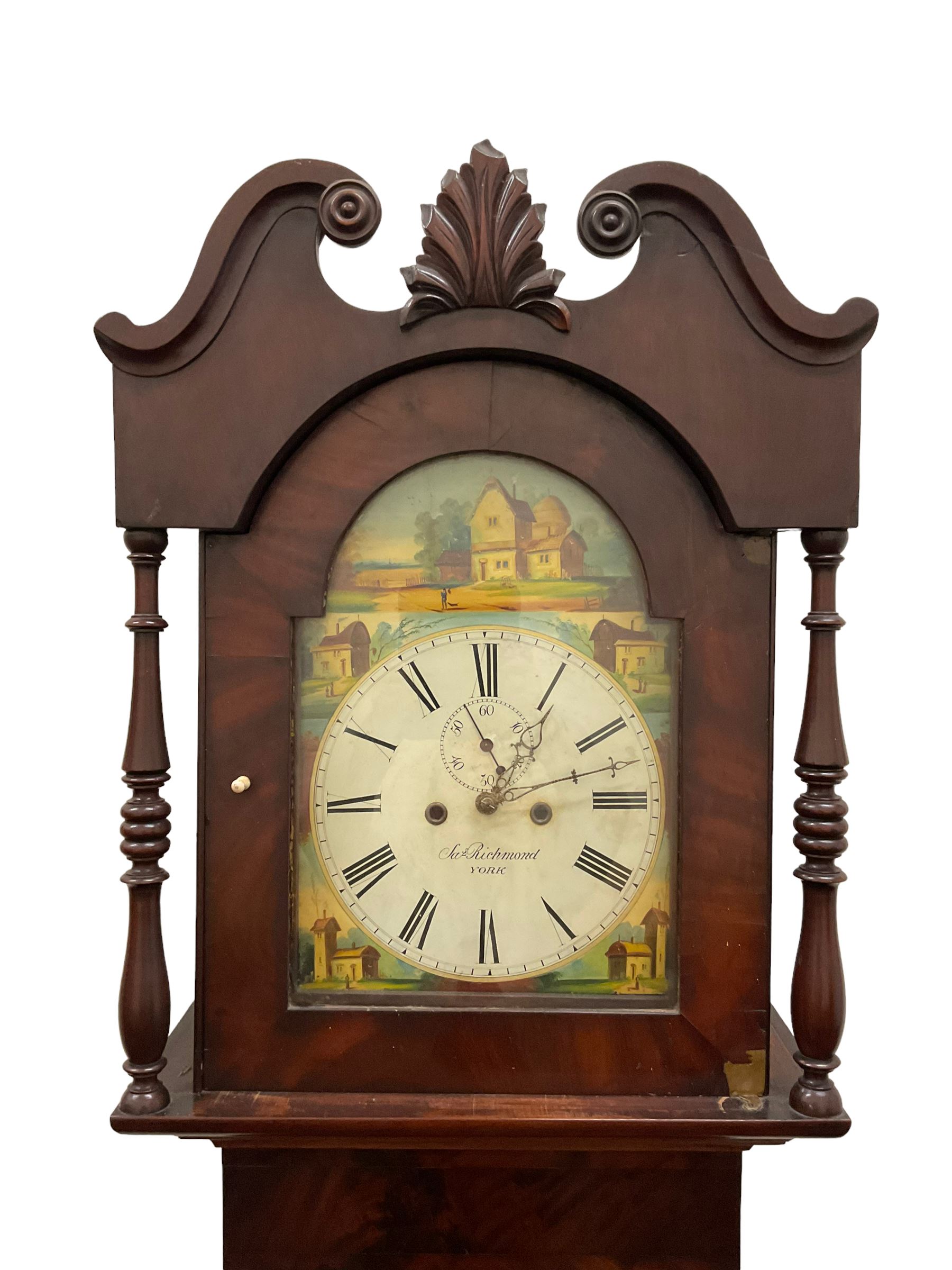 Joseph Richmond of York -  late19th century mahogany cased 30 hr longcase clock, with a swans neck pediment, break arch hood door flanked by ring turned pilasters, broad trunk with part-length recessed pillars and a short trunk door on a broad plinth with a recessed panel, fully painted dial with depictions of country cottages to the spandrels and break arch, with Roman numerals and minute track, stamped brass hands, dummy winding arbors and dummy seconds hand, dial pinned directly to a chain driven count wheel striking movement, striking the hours on a bell. With pendulum and weight.
Joseph Richmond of Fossgate was a respected clockmaker in 19th century York, maintaining the clocks in York Minster and other civic buildings in York.