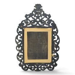 Rococo style gilt wall mirror, the shaped rectangular bevelled plate within a pierced frame of scrolling acanthus leaves, surmounted by a foliate crest