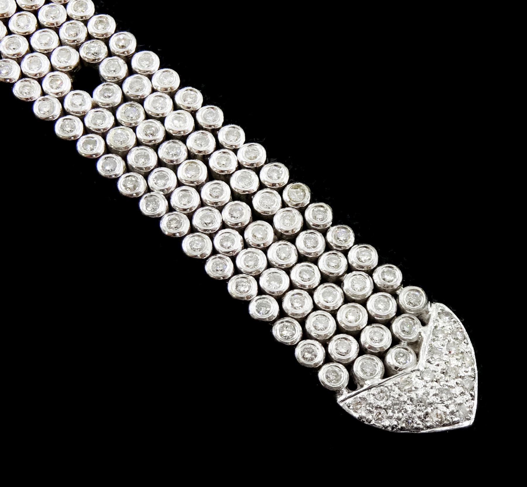 14ct white round brilliant cut diamond belt bracelet, the bracelet with rubover set diamonds, the buckle and clasp with pave set diamonds, stamped 14K, total diamond weight 5.35 carat