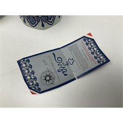 De Porceleyne Fles Delftware blue and white covered jar, of fluted baluster form, with floral and insect decoration, upon an octagonal foot, the octagonal cover with urn shaped finial, H32cm