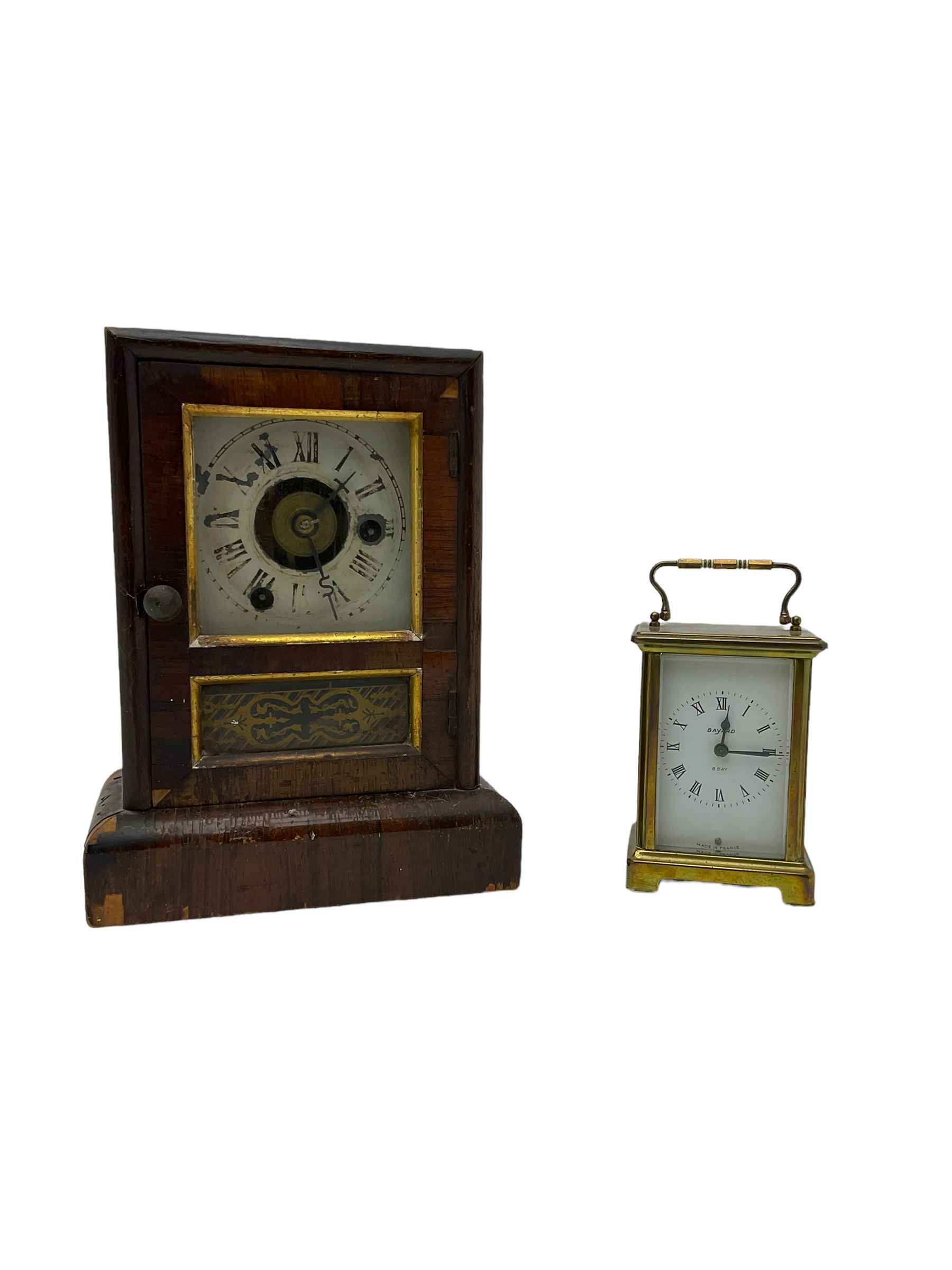 A French carriage clock by Duverdrey & Bloquel c1920, with three glass panels and white enamel dial, Roman numerals and minute markers, lever platform escapement and integral winding key. Together with a late 19th century American spring driven 30hr alarm clock by Seth Thomas of Connecticut USA c1890, in a wooden case with a white dial and brass alarm setting disc.   


