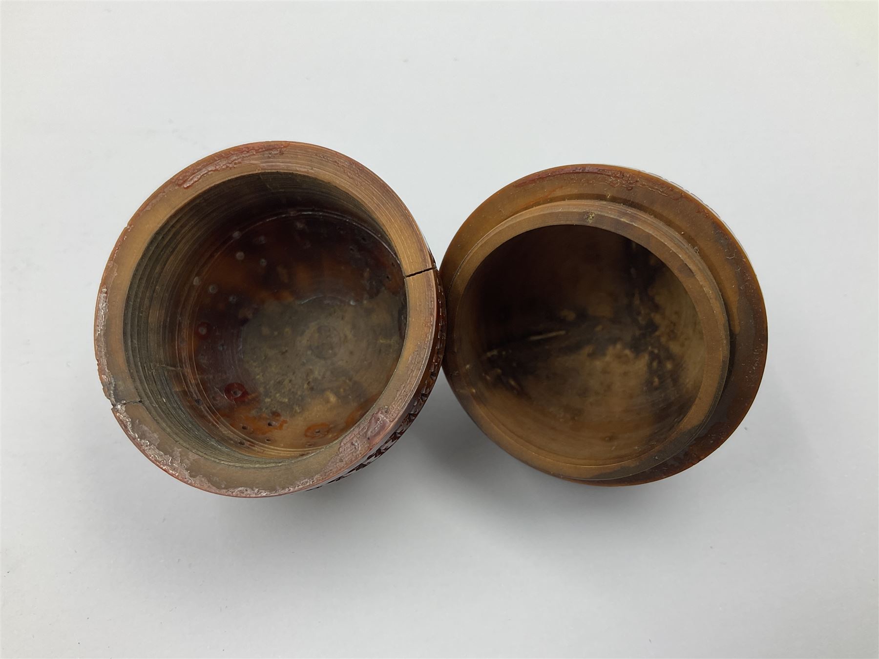 Three 19th century coquilla nut pomanders or flea catchers, two of egg shaped form and the third of barrel from with carved and pierced decoration and screw threaded join, largest H8cm